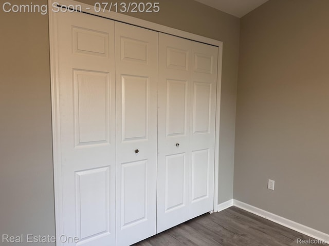 820 Woodhaven Dr, Commerce Twp, MI 48390 - unfurnished bedroom featuring a closet and dark wood-type flooring