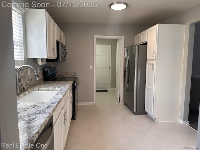 820 Woodhaven Dr, Commerce Twp, MI 48390 - kitchen featuring stainless steel fridge, electric range, white cabinets, and light stone counters