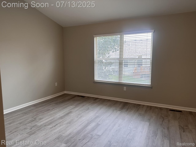 820 Woodhaven Dr, Commerce Twp, MI 48390 - empty room featuring wood finished floors and baseboards
