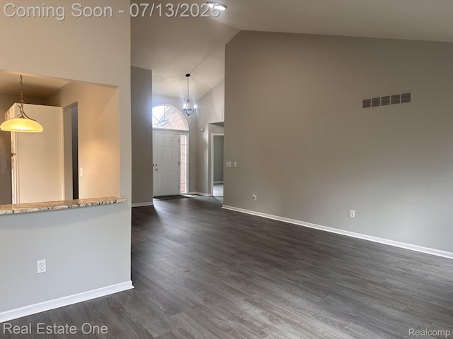 820 Woodhaven Dr, Commerce Twp, MI 48390 - unfurnished living room with dark wood-style floors and high vaulted ceiling