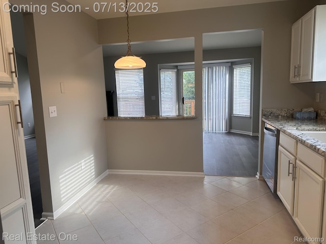 820 Woodhaven Dr, Commerce Twp, MI 48390 - kitchen with stainless steel dishwasher, light stone counters, decorative light fixtures, light tile patterned flooring, and white cabinets