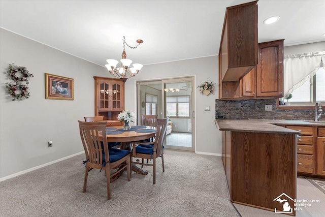 15930 Drysdale St, Southgate, MI 48195 - dining room featuring a chandelier, light carpet, and ornamental molding