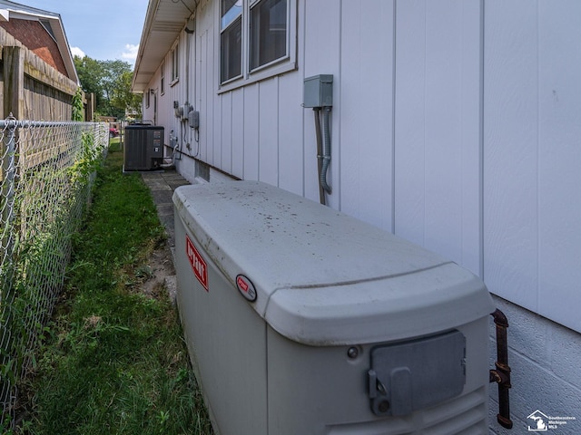 1405 Arbor Ave, Monroe, MI 48162 - exterior view of a cooling unit and board and batten siding