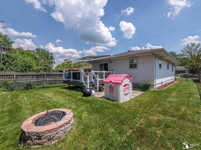 1405 Arbor Ave, Monroe, MI 48162 - back of property with a fire pit, a deck, and a fenced backyard