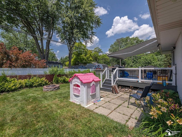 1405 Arbor Ave, Monroe, MI 48162 - fenced backyard with a fire pit and a deck