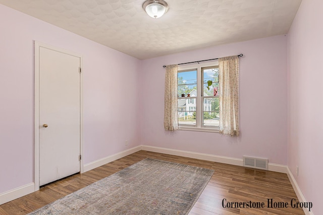8611 Byron Center Ave SW, Byron Center, MI 49315 - spare room featuring baseboards and wood finished floors