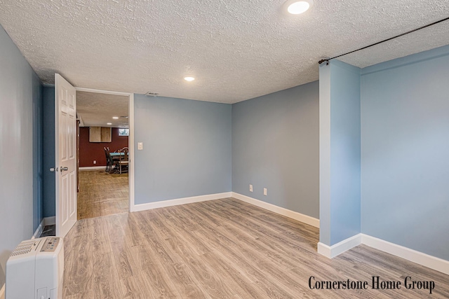 8611 Byron Center Ave SW, Byron Center, MI 49315 - spare room with a textured ceiling, light wood-type flooring, and recessed lighting