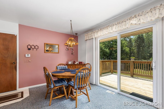 1236 S Van Bruggen Dr, Plainwell, MI 49080 - carpeted dining space featuring a chandelier