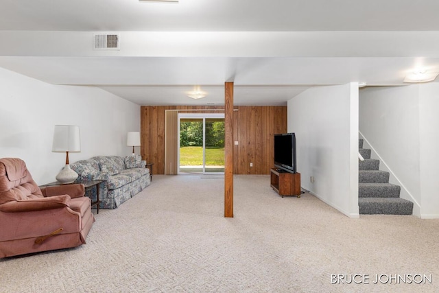 1236 S Van Bruggen Dr, Plainwell, MI 49080 - carpeted living room featuring wood walls and stairway