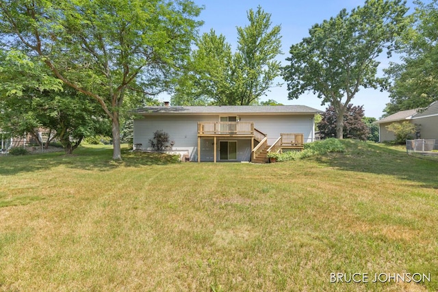 1236 S Van Bruggen Dr, Plainwell, MI 49080 - back of property with stairs, a deck, and a yard