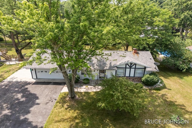 1236 S Van Bruggen Dr, Plainwell, MI 49080 - view of front of home featuring asphalt driveway, a front yard, a garage, and a shingled roof