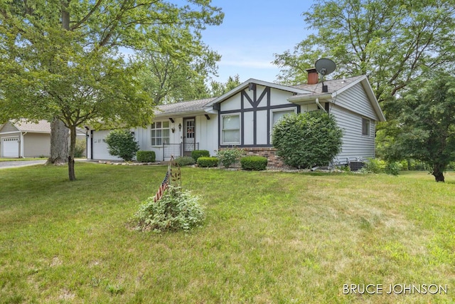 1236 S Van Bruggen Dr, Plainwell, MI 49080 - view of front facade featuring a front yard and a garage