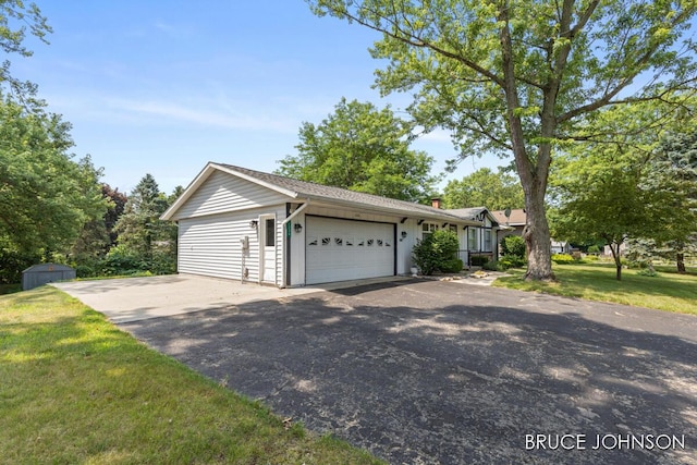 1236 S Van Bruggen Dr, Plainwell, MI 49080 - view of front of house with an attached garage, a front yard, and driveway