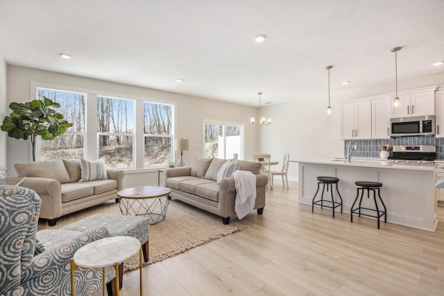 4818 Hidden River Ave SW Unit 51, Wyoming, MI 49418 - living area with plenty of natural light, a chandelier, light wood-style floors, and recessed lighting