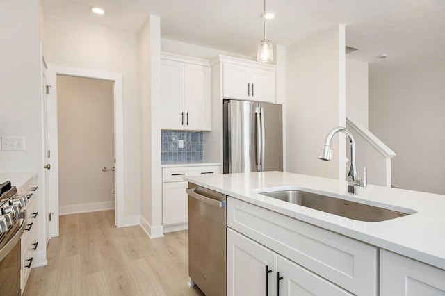 4818 Hidden River Ave SW Unit 51, Wyoming, MI 49418 - kitchen featuring appliances with stainless steel finishes, light wood finished floors, white cabinetry, light countertops, and decorative backsplash