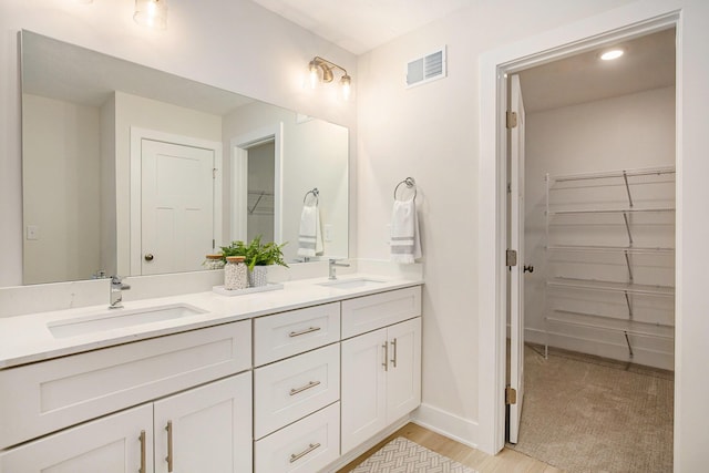 4818 Hidden River Ave SW Unit 51, Wyoming, MI 49418 - full bath featuring double vanity, a walk in closet, wood finished floors, and recessed lighting