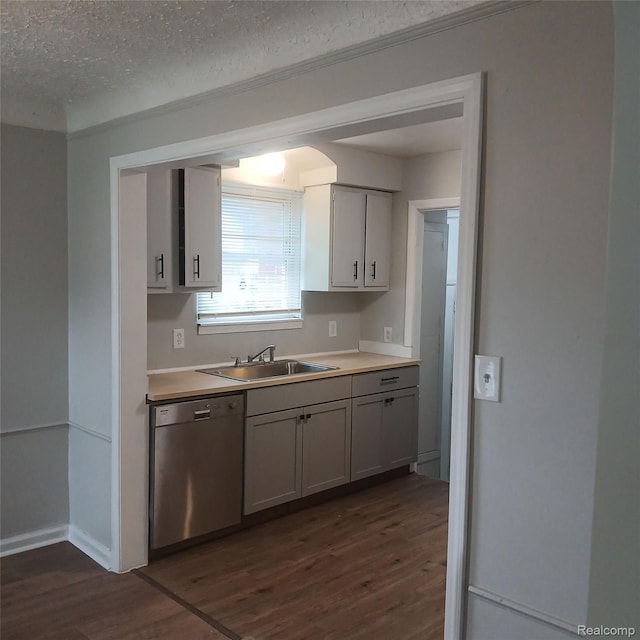19145 Fielding St, Detroit, MI 48219 - kitchen featuring stainless steel dishwasher, dark wood-type flooring, light countertops, and a textured ceiling