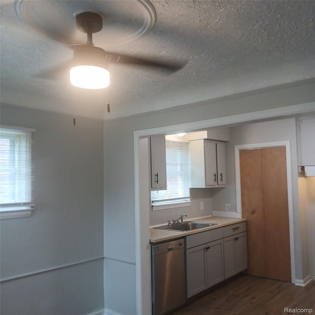 19145 Fielding St, Detroit, MI 48219 - kitchen featuring dishwasher, dark wood-type flooring, light countertops, and a textured ceiling