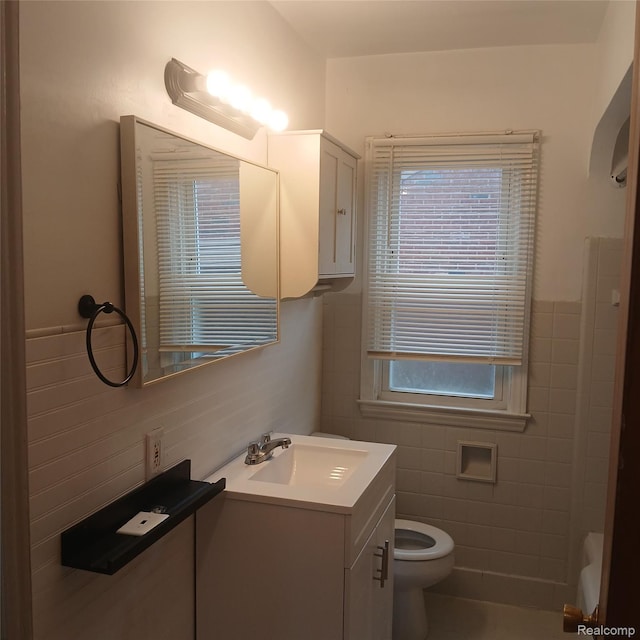 19145 Fielding St, Detroit, MI 48219 - bathroom featuring tile walls, vanity, and a wainscoted wall