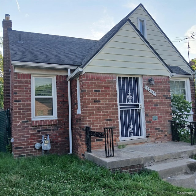 19145 Fielding St, Detroit, MI 48219 - back of property featuring roof with shingles, brick siding, and a chimney