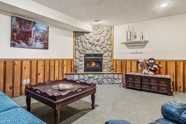 16253 1st Ln, Union Pier, MI 49129 - carpeted living room with wainscoting, a textured ceiling, wooden walls, and a stone fireplace