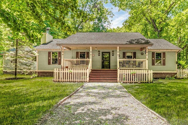 16253 1st Ln, Union Pier, MI 49129 - view of front of property featuring a porch, a chimney, a front lawn, and a shingled roof