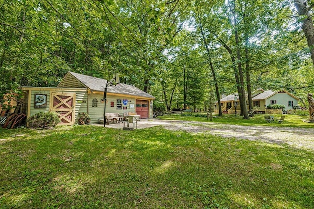 16253 1st Ln, Union Pier, MI 49129 - view of grassy yard featuring driveway and a garage