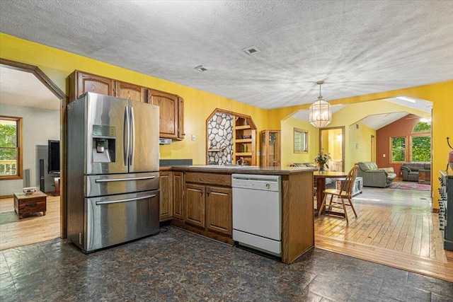 16253 1st Ln, Union Pier, MI 49129 - kitchen with white dishwasher, stainless steel fridge with ice dispenser, a peninsula, plenty of natural light, and a textured ceiling