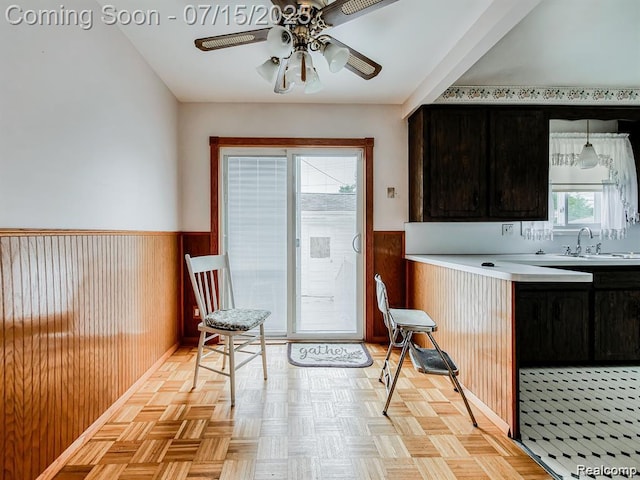 32508 Avondale St, Westland, MI 48186 - kitchen with a wainscoted wall, wood walls, ceiling fan, and light countertops