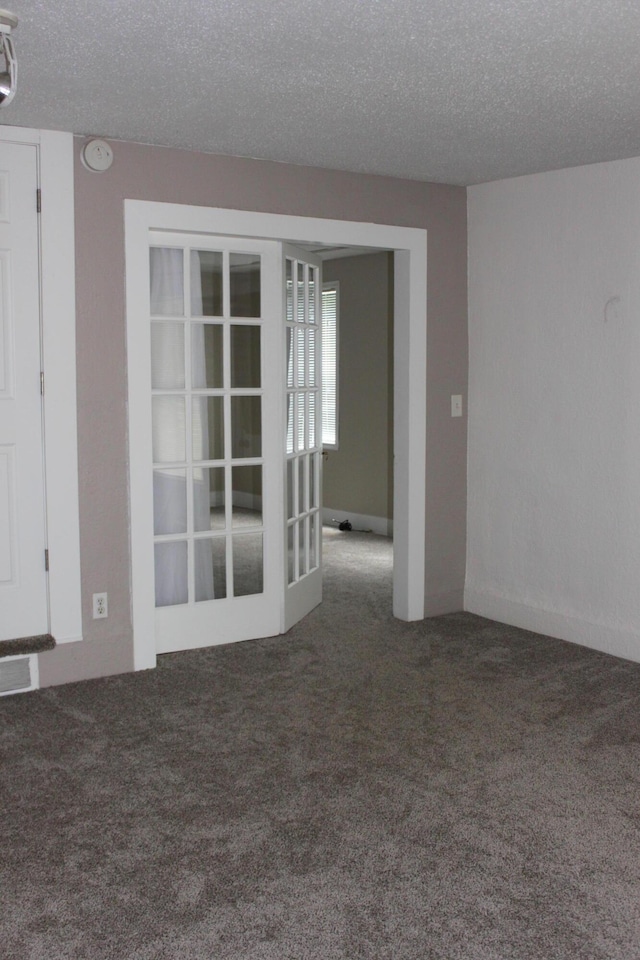 411 Block Rd, Coldwater, MI 49036 - empty room with carpet floors, a textured ceiling, french doors, and a smoke detector