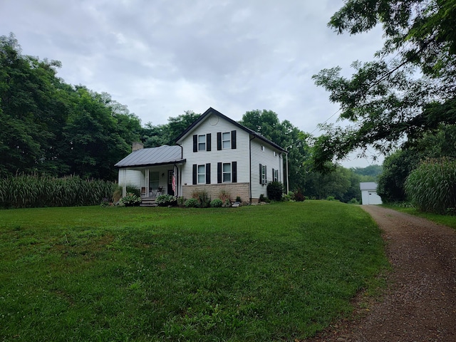 411 Block Rd, Coldwater, MI 49036 - traditional-style home featuring a porch, a front yard, and stone siding