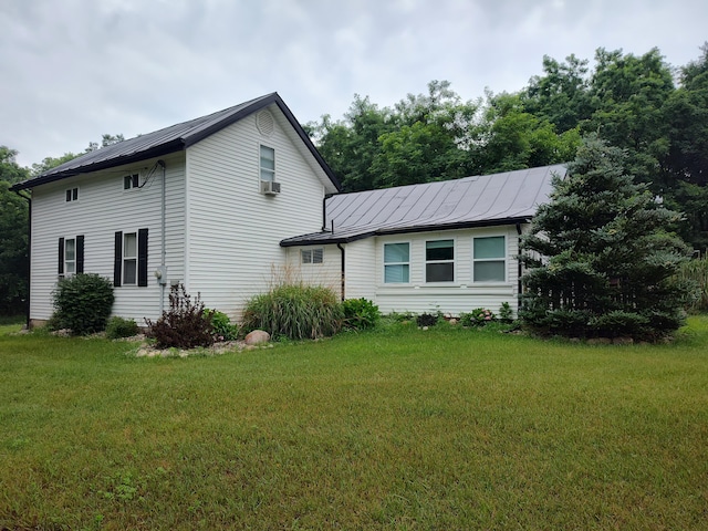 411 Block Rd, Coldwater, MI 49036 - view of property exterior with a standing seam roof, a metal roof, a yard, and cooling unit