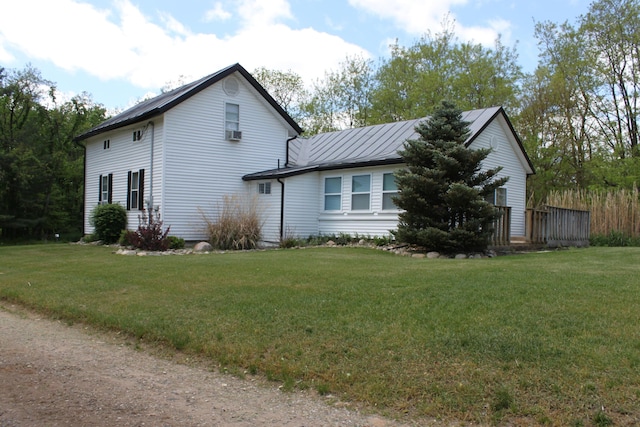 411 Block Rd, Coldwater, MI 49036 - view of side of home with a yard, a standing seam roof, cooling unit, and a metal roof