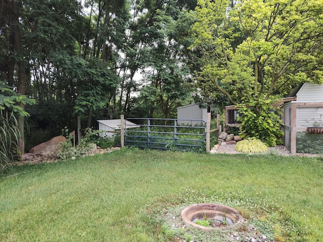 411 Block Rd, Coldwater, MI 49036 - view of green lawn with a fire pit and an outdoor structure