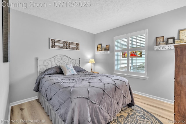 77 Sedum, Howell, MI 48843 - bedroom with light wood-style floors and a textured ceiling