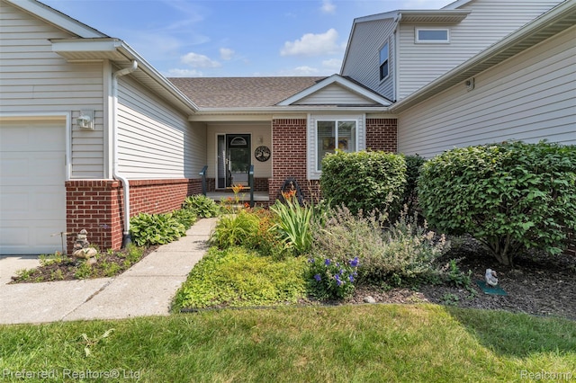77 Sedum, Howell, MI 48843 - property entrance featuring brick siding, a garage, and a shingled roof