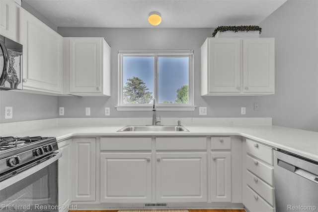 77 Sedum, Howell, MI 48843 - kitchen with appliances with stainless steel finishes, white cabinetry, and light countertops