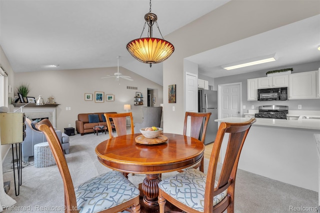 77 Sedum, Howell, MI 48843 - dining room with light colored carpet, vaulted ceiling, and a ceiling fan