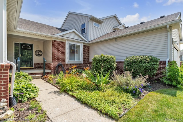 77 Sedum, Howell, MI 48843 - entrance to property with brick siding, roof with shingles, and a porch