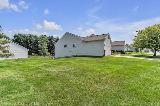 77 Sedum, Howell, MI 48843 - view of side of home featuring a lawn, concrete driveway, an attached garage, and roof with shingles
