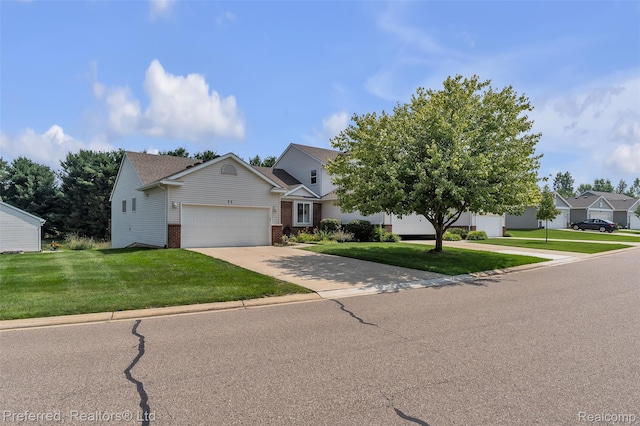 77 Sedum, Howell, MI 48843 - view of front of home featuring brick siding, a front lawn, an attached garage, and concrete driveway