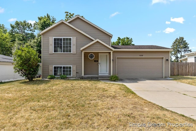 1026 Coldbrook St NE, Grand Rapids, MI 49503 - tri-level home featuring a garage and concrete driveway