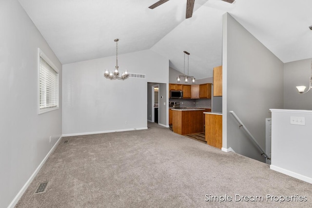 1026 Coldbrook St NE, Grand Rapids, MI 49503 - unfurnished living room with a chandelier, a ceiling fan, carpet floors, and high vaulted ceiling