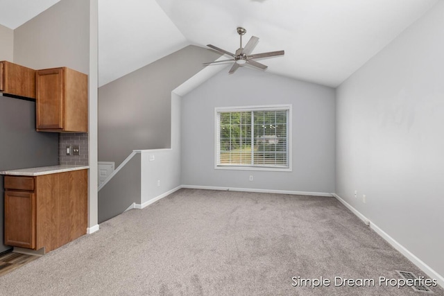 1026 Coldbrook St NE, Grand Rapids, MI 49503 - unfurnished living room with lofted ceiling, a ceiling fan, and carpet floors