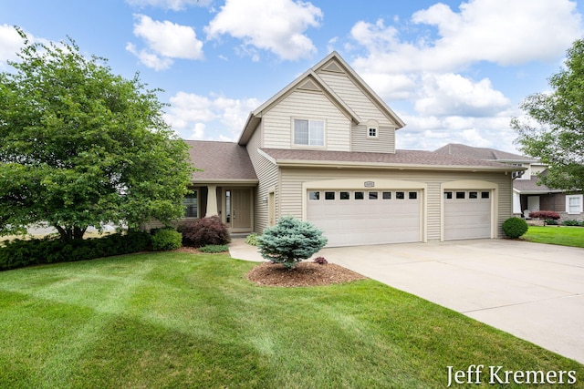 5692 Nile Dr SW, Wyoming, MI 49418 - traditional-style house with driveway, a front lawn, a shingled roof, and a garage