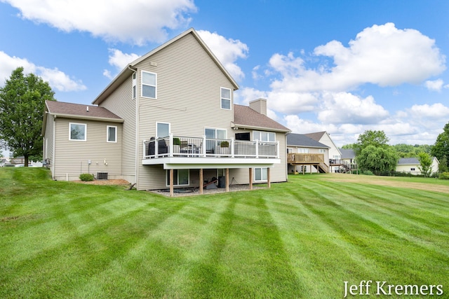 5692 Nile Dr SW, Wyoming, MI 49418 - rear view of house featuring a wooden deck, a chimney, and a yard