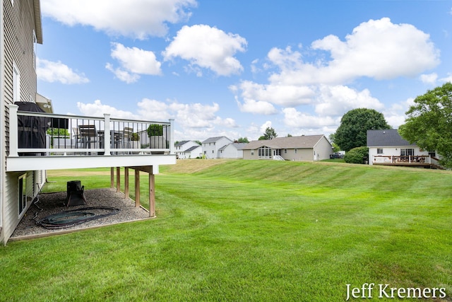 5692 Nile Dr SW, Wyoming, MI 49418 - view of grassy yard featuring a wooden deck and a residential view
