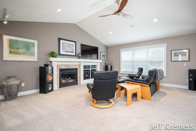 5692 Nile Dr SW, Wyoming, MI 49418 - carpeted living area with vaulted ceiling, a ceiling fan, a tiled fireplace, and recessed lighting