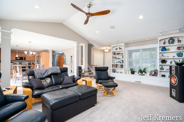 5692 Nile Dr SW, Wyoming, MI 49418 - living room featuring a ceiling fan, carpet flooring, lofted ceiling, ornate columns, and a chandelier