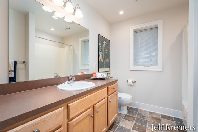 5692 Nile Dr SW, Wyoming, MI 49418 - full bath with vanity, stone finish floors, curtained shower, and recessed lighting